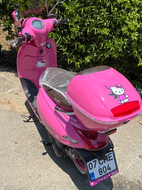 Hello Kitty scooter parked among greenery in Alanya