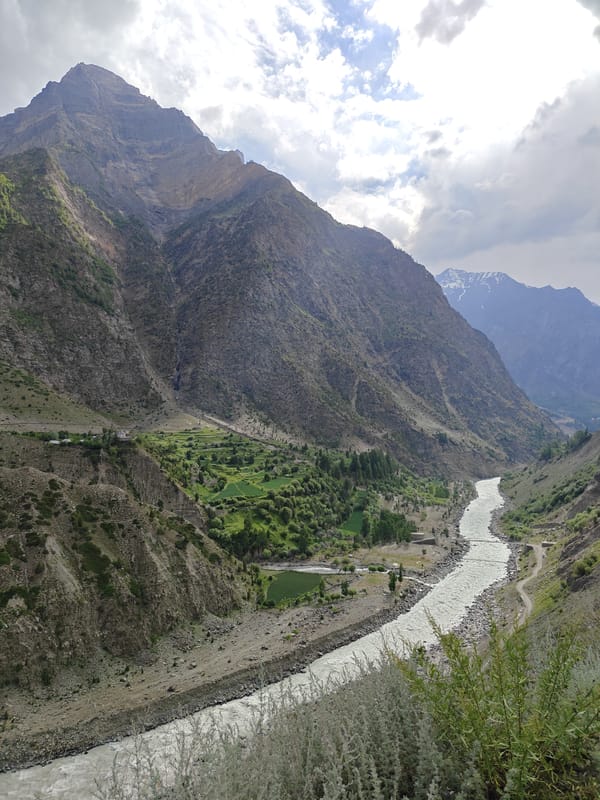 Riding through Kirting's glacial river valley in the Himalayas