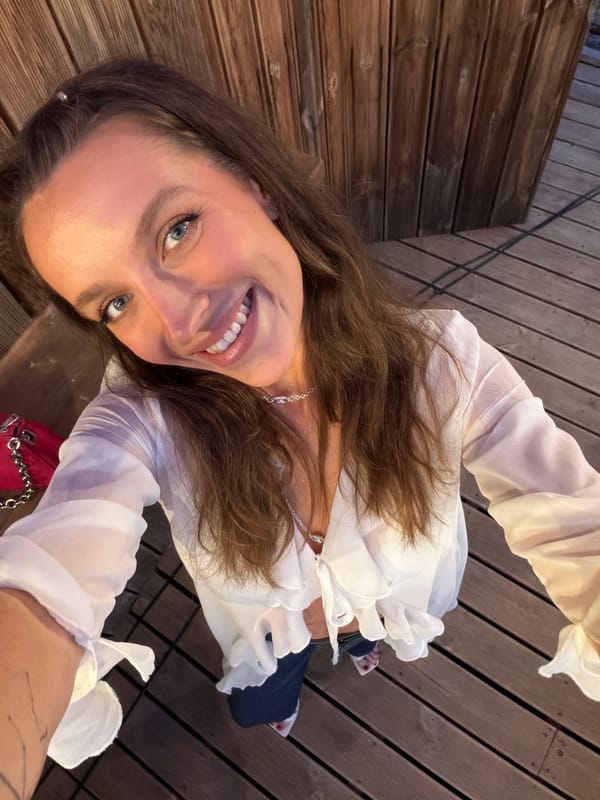 Woman takes smiling selfie in Bigova, Montenegro