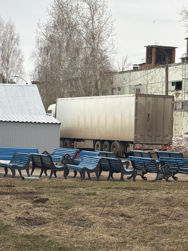 Blue park benches documented along roadside in Chaikovsky, Russia