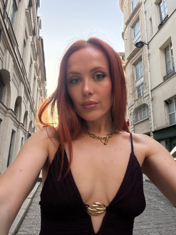 Woman takes selfie among Paris buildings