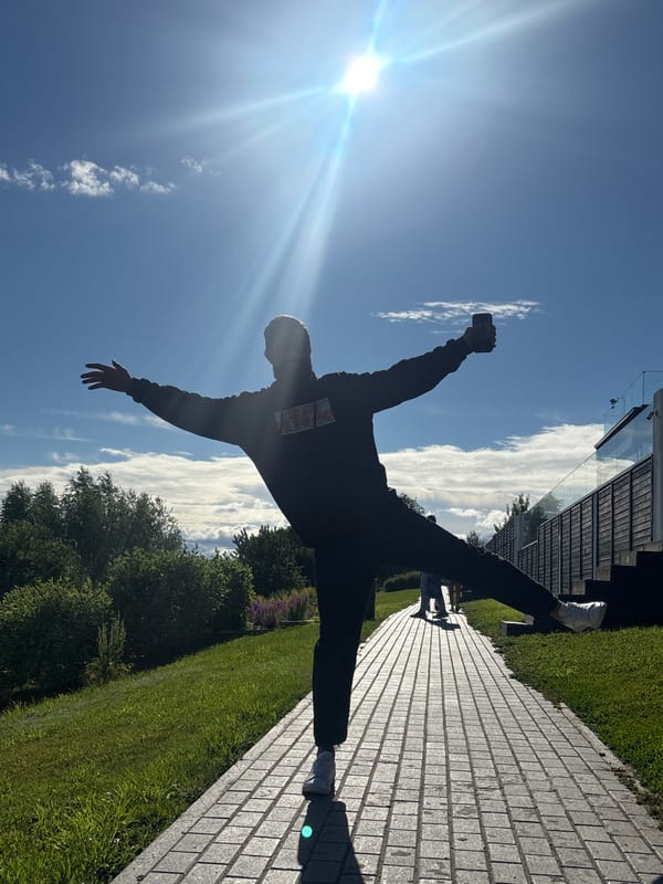 Handstand silhouetted against a sunny Tolyatti sky