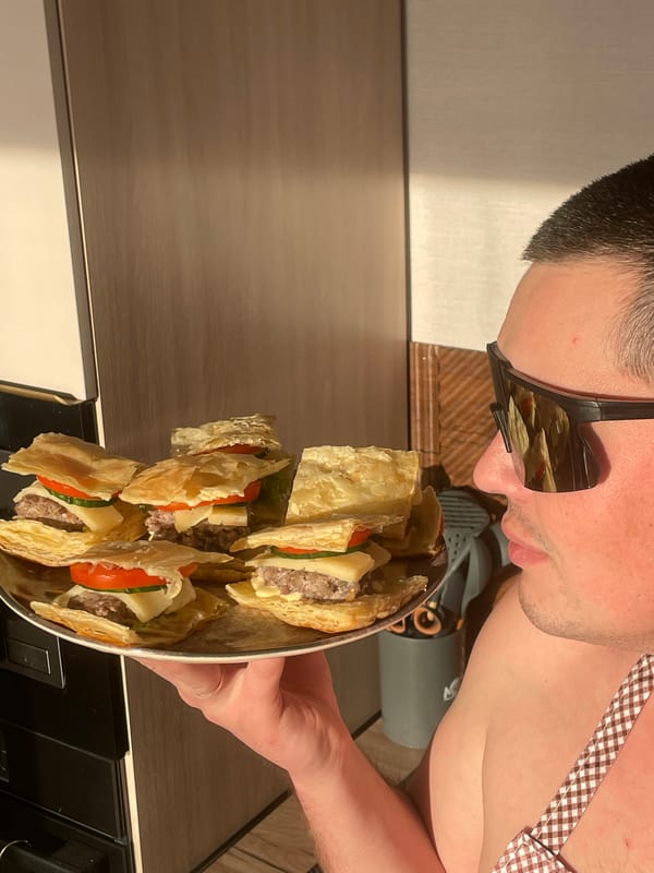 Baker displays fresh puff pastry sandwiches in Russian village