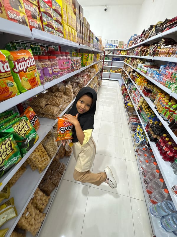 Child's shopping trip and cat encounters in Kebonsari, Indonesia