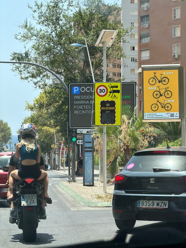 Midday traffic and street life in sunny Benidorm