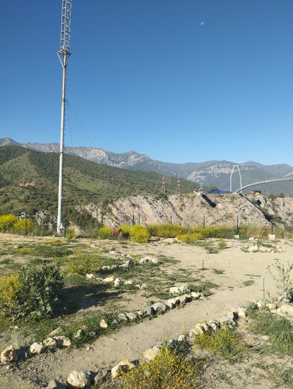 Morning light across Dardar's mountain roads, walkways, and valley views