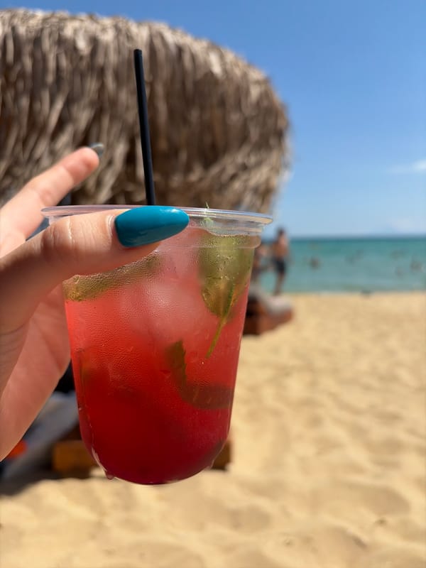 Cold drinks and thatched shade on a Greek beach afternoon