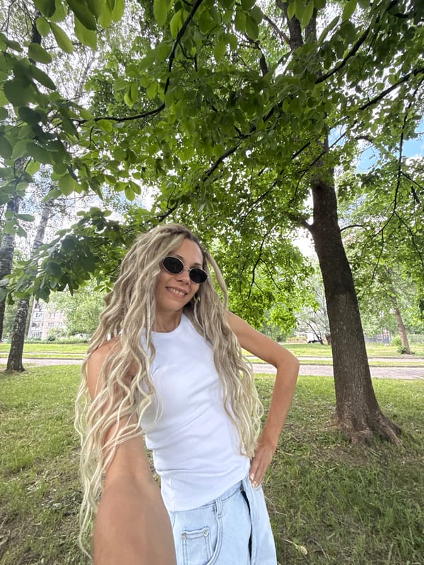 Woman poses for selfies during park visit in Rusanovo