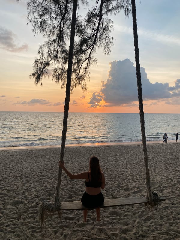 Woman enjoys sunset moment on Choeng Thale beach