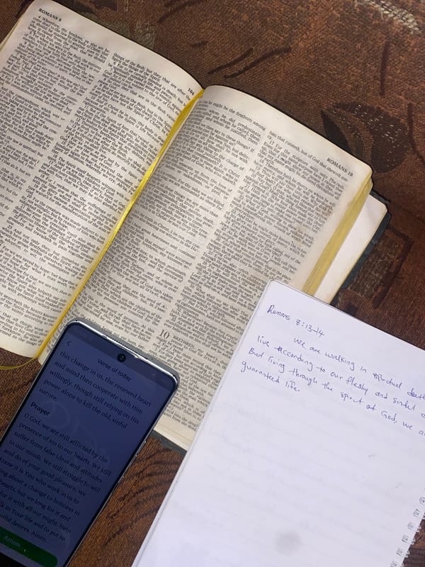 Study materials including Bible arranged on fabric surface