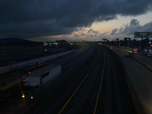 Lagos transportation corridor observed under cloudy dusk sky
