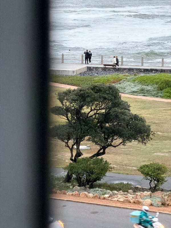 Cape Town sunset witnessed from coastal promenade during rough seas