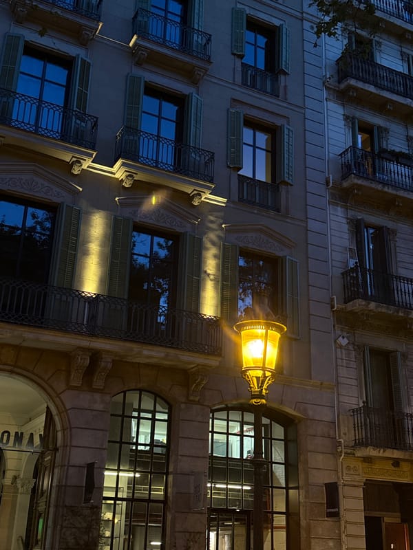 Barcelona building facade documented at night with ornate balconies