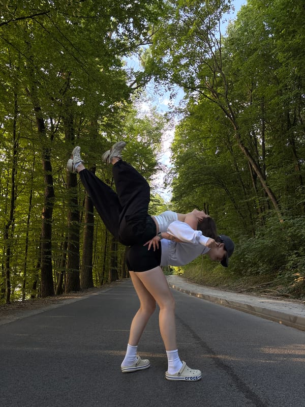 Acrobatic pose on a forested road in Ternopil