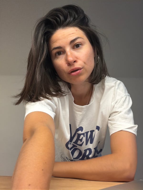 Woman in New York shirt poses indoors in Budva