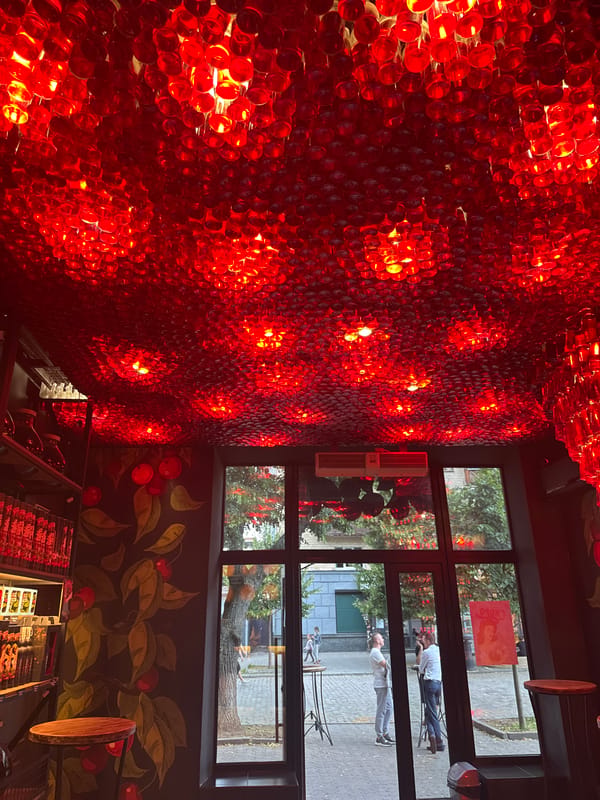 Red bottle chandeliers and flower beds in Poltava