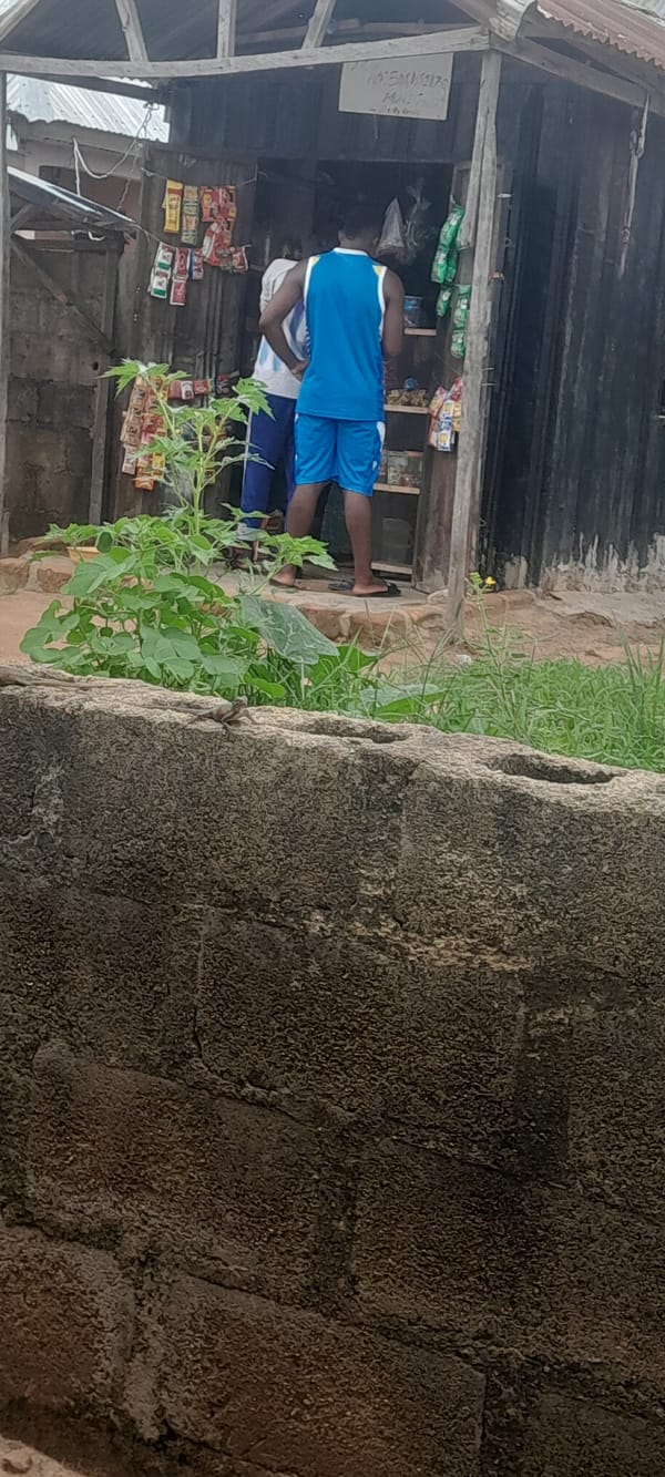 Roadside stall, a brick wall, and two Pidgin memes