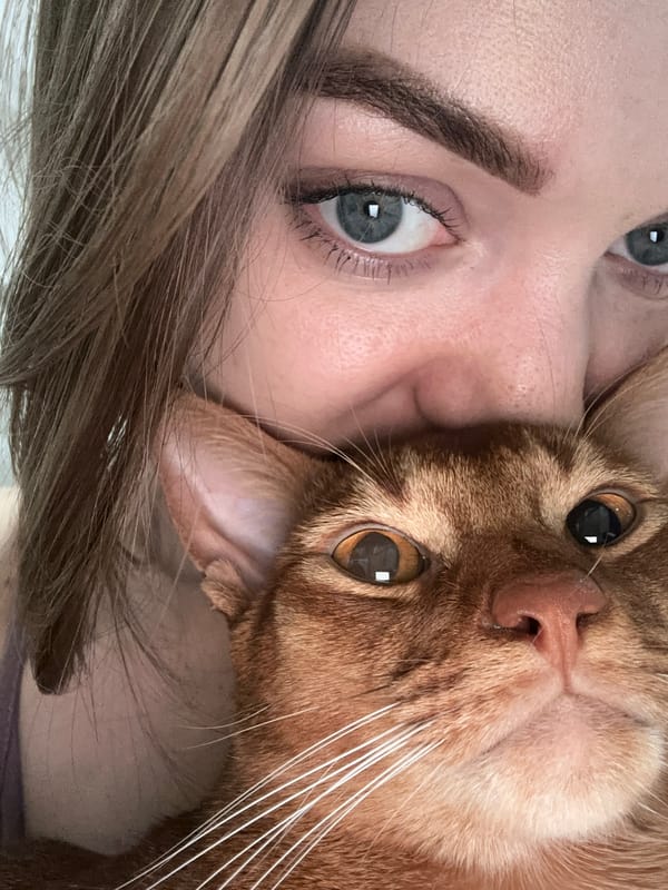 Woman poses with orange cat in Kazan selfie