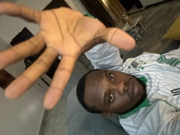 Man watches TV, rests on couch in Nigerian home