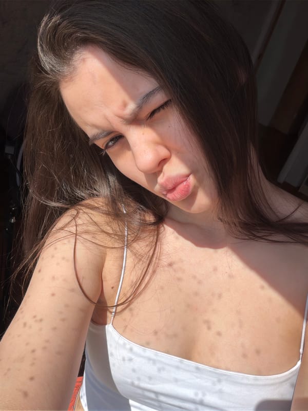 Woman takes selfies in sunlit room in Chaikovsky