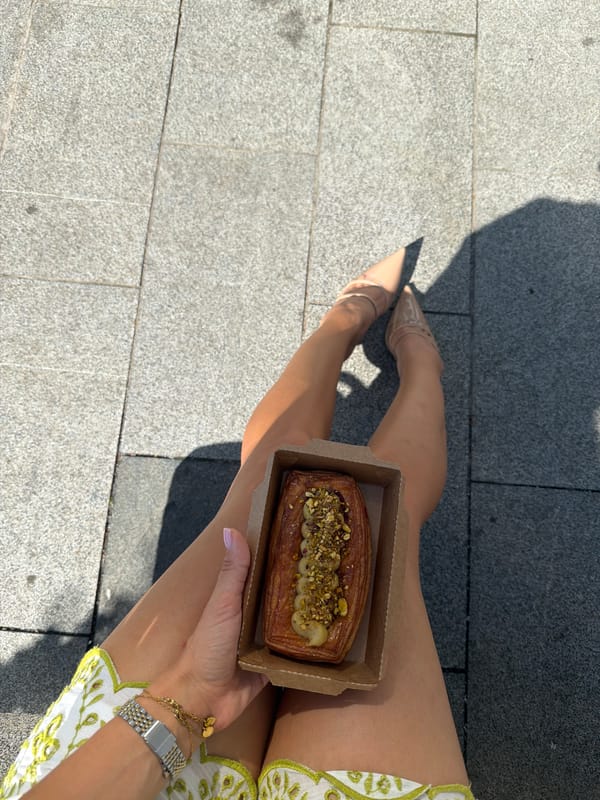 Pastry break on a sunny stone square in Batumi