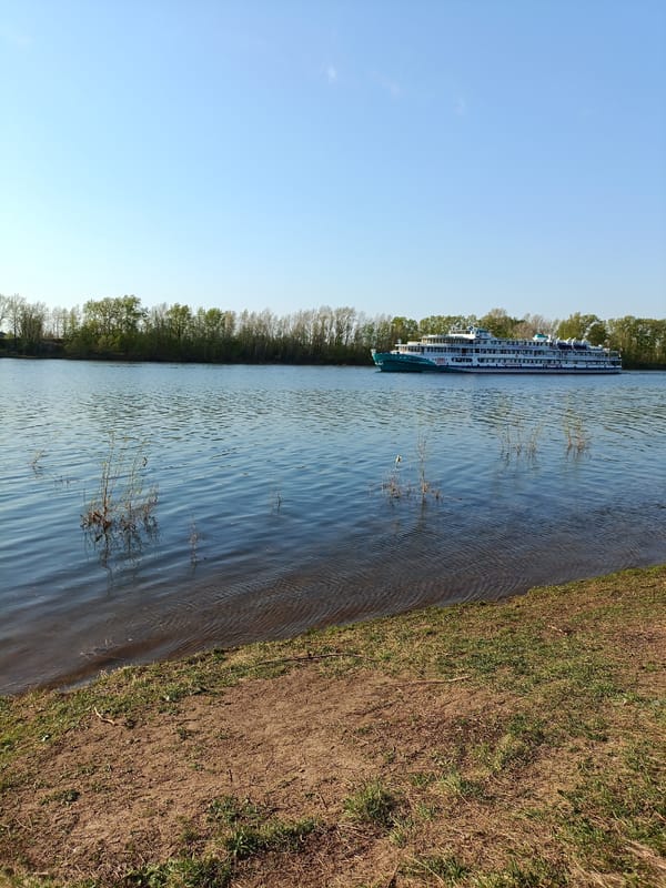 Cruise ship travels Kama River near Chaikovsky on sunny day