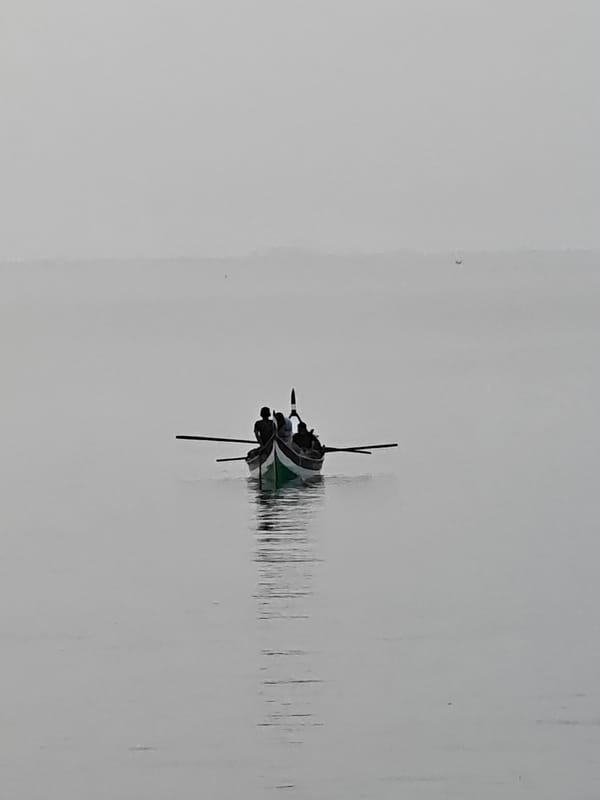Traditional boats navigate calm waters near Lhokseumawe, Indonesia
