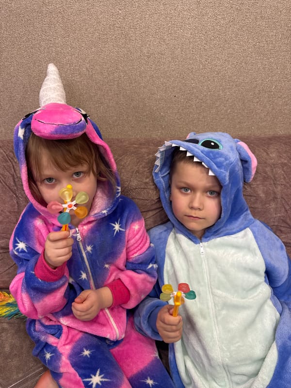 Children rest indoors in Stitch costume, Chaikovsky Russia