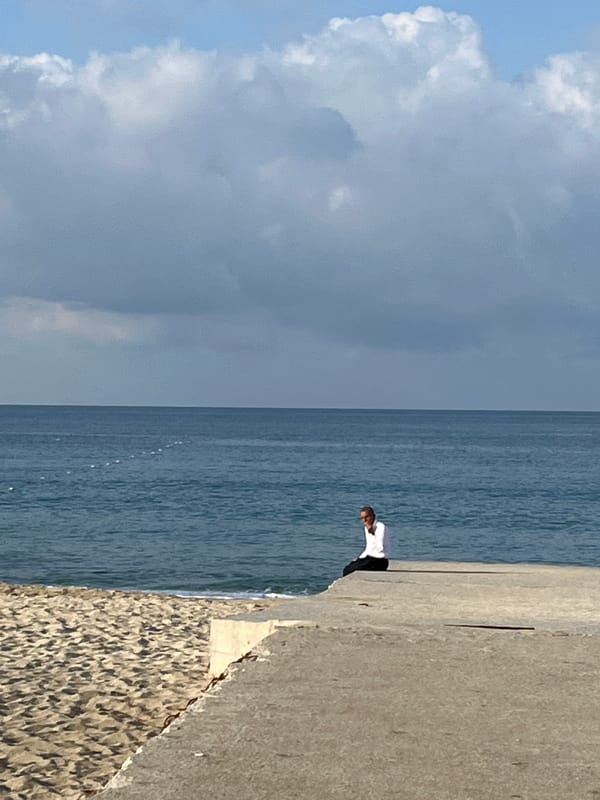 Man stands on seaside concrete structure in Alanya