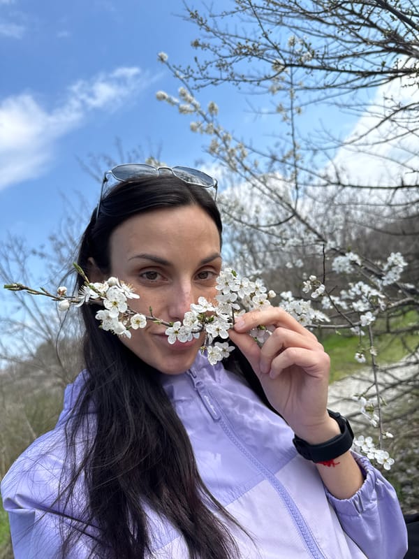 Woman poses with flowering branch in Pleven, Bulgaria