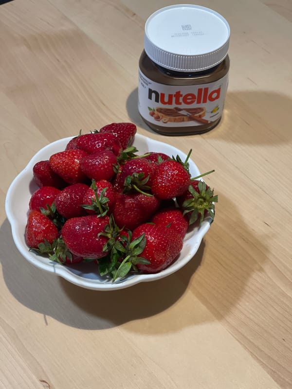 Woman enjoys strawberry and Nutella snack in Izhevsk home