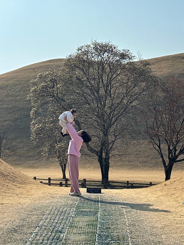 Family visits ancient tombs in Gyeongju during early morning hours