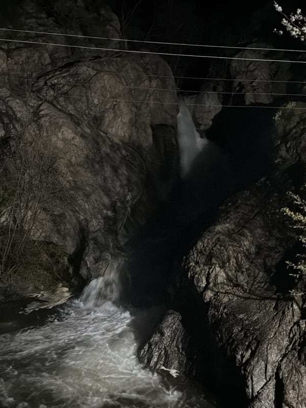 Nighttime waterfall observed cascading through rocky gorge in Karlovo