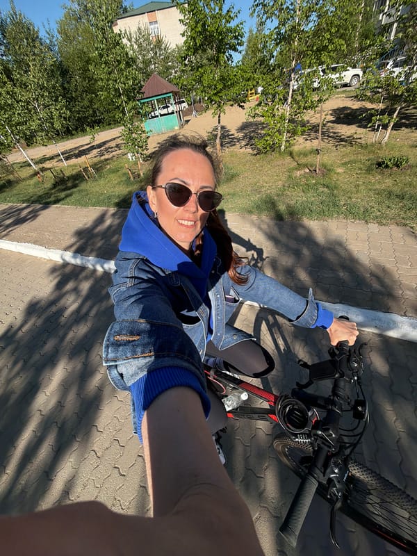 Woman cycles through Birobidzhan streets on spring morning