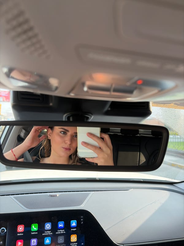 Woman takes selfie in car rearview mirror in Mexico
