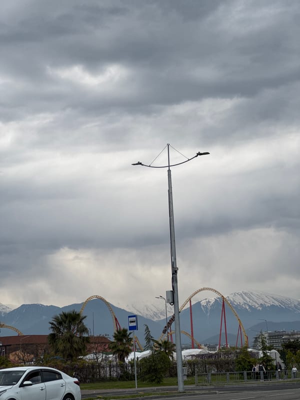 Overcast day captures street life near Sirius amusement park