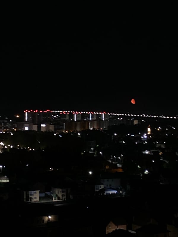 Nighttime skyline and moon observed in Kazan, Russia