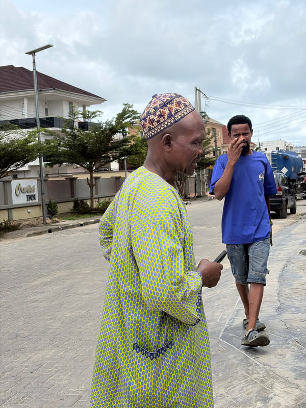 Two men interact on street in Igboefon, Nigeria