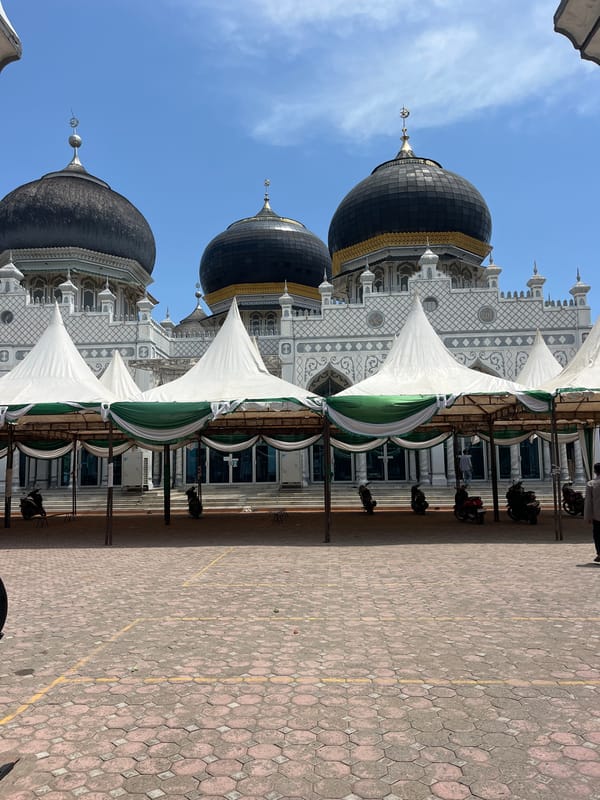 Visitor documents Indonesian mosque architecture and worshippers in morning visit
