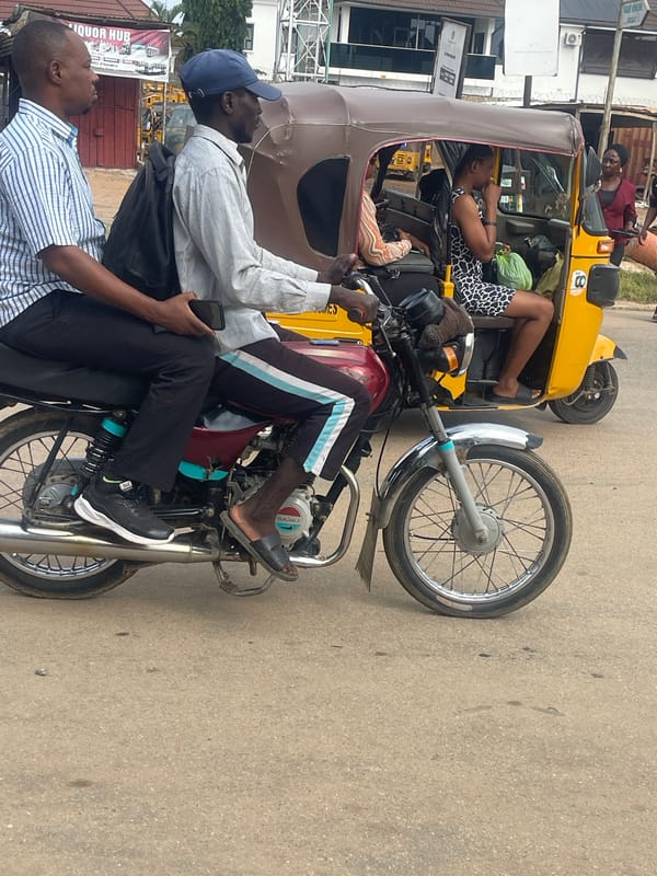 Morning motorcycle traffic and street life in Abuja