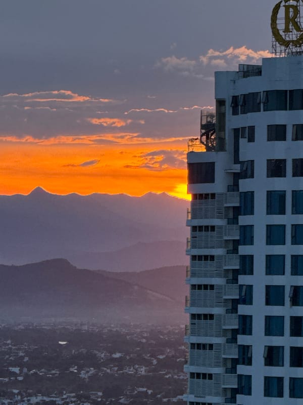 Sunset over Nha Trang, high-rises, coastline, and golden skies