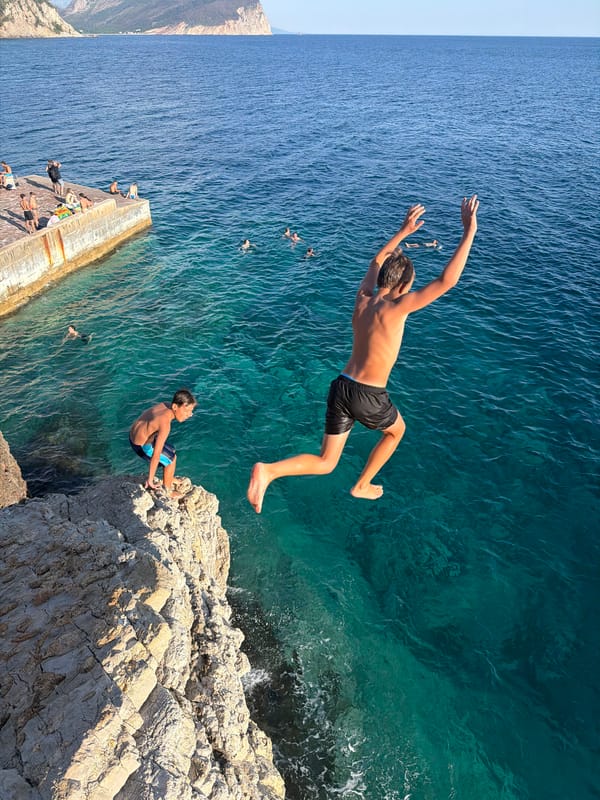 Cliff jumping into turquoise Adriatic waters at Petrovac