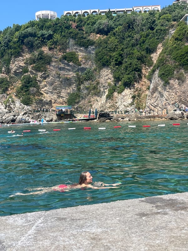 Sunny swim session off a Budva pier, Adriatic coast