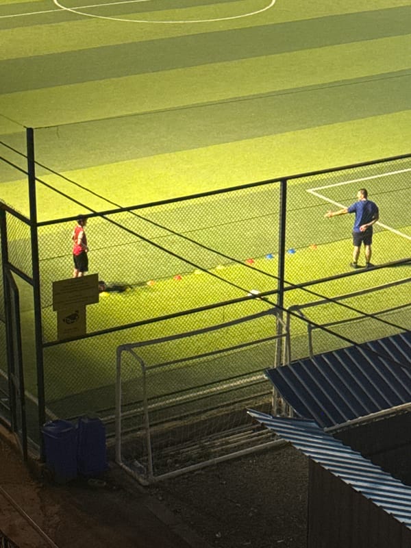 Soccer practice at dusk on a Tbilisi turf field