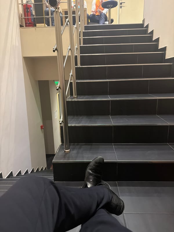 Person sits on staircase steps in Sofia