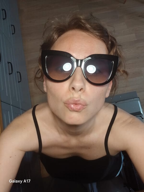 Woman documents sunglasses selfie session in Yekaterinburg apartment