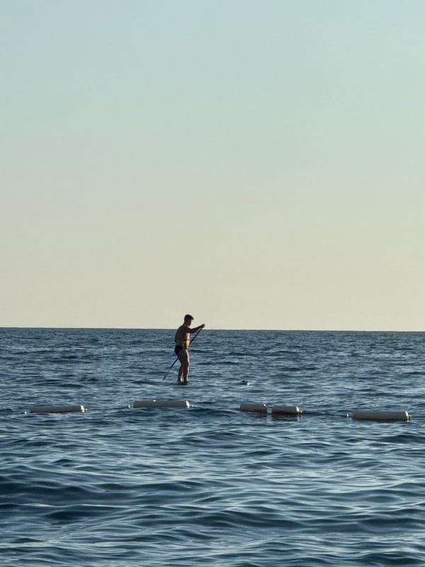 Paddleboarding at golden hour off the Pržno coast