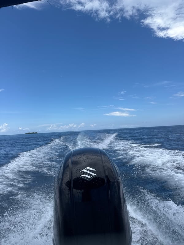 Motorboat travels ocean waters near Rasdhoo, Maldives morning