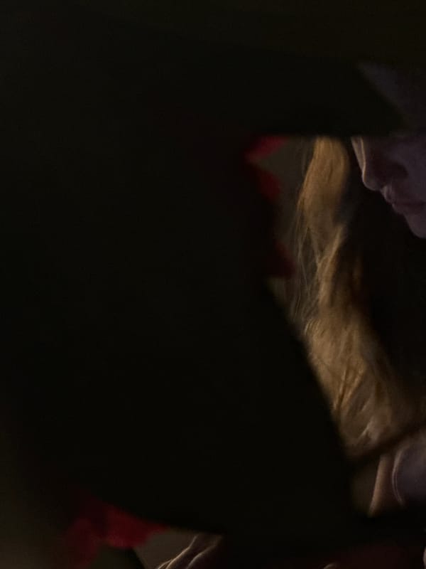 Person spotted in dimly lit room with flowers in Erba