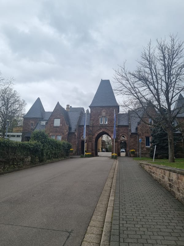 Historic stone building with arched entrance photographed in Saarbrücken